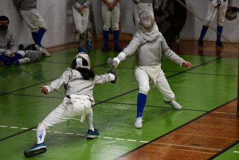 FOIL, SABER, EPEE. Sophomore Nora Shaughnessy competes in a saber bout, beating Blake in two out the three rounds she participated in. Saber is considered the most aggressive out of the three weapons used in fencing due to the increased amount of slashing involved, and the fact that the target area is anywhere above players’ waists.
