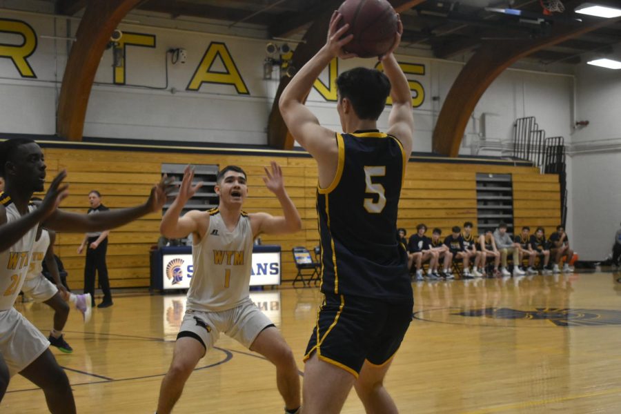 Senior Clarke Baskerville looks for a pass as defenders surround him