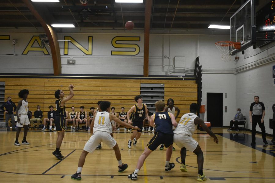 Senior Mukeil Rizvi shoots his free throw, as teamates box out