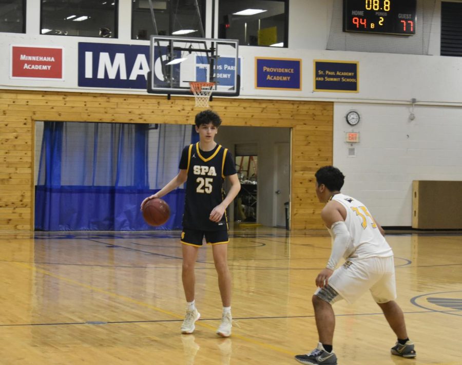 Junior Aaron Lindeman dribbles the ball up the court, looking for an open teammate