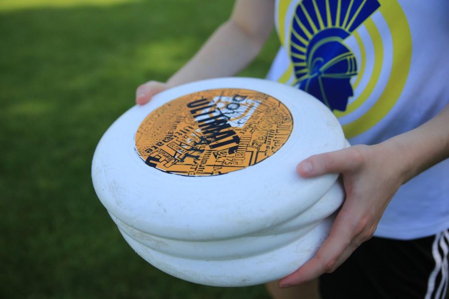 ULTIMATE+FRISBEES.+A+spartan+ultimate+player+holds+a+stack+of+frisbees.+