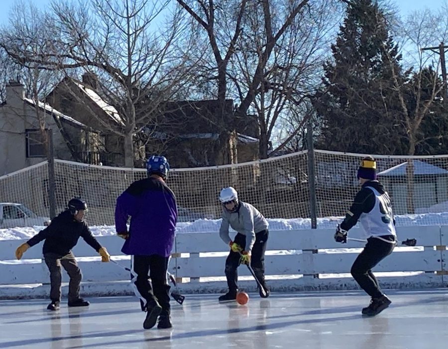 Senior+Sam+Rawdon+dribbles+through+defenders+at+a+saturday+broomball+pickup+game.