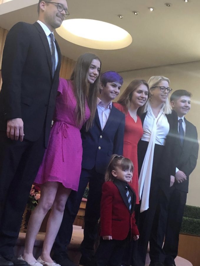 Eli Peres (far right) stands with his family for a snazzy photo.