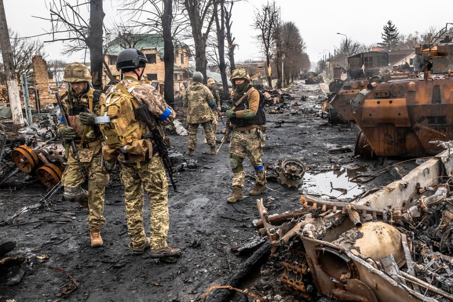 Ukrainian soldiers inspecting the charred remains of a Russian military convoy in Bucha on April 2. 