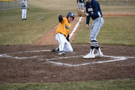 SLIDING IN: Captain Will Steinhacker slides into home base giving SPA another point.