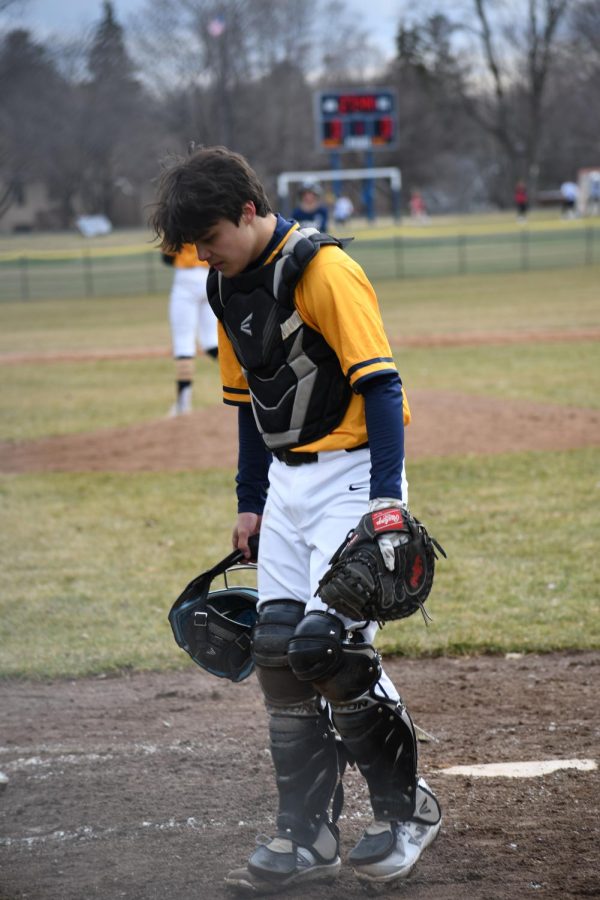 THE WALK BACK: Catcher Griffin Schwab-Mahoney walks back to the dugout after an inning.