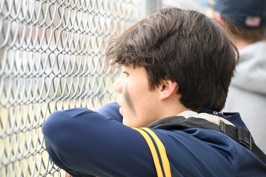 WAITING: Catcher Griffin Schwab-Mahoney watches the game as he waits for his turn to get in the game.