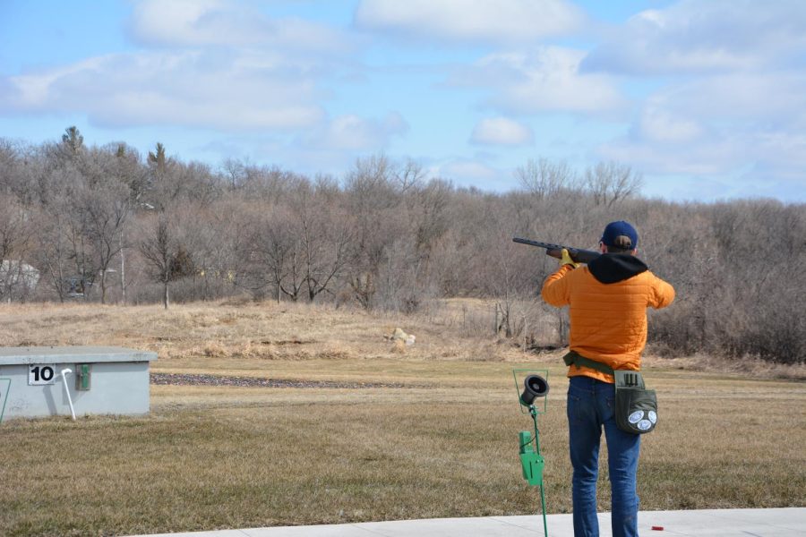 SHATTERED CLAY. Team captain Jack O'Brien takes aim during a round of practice at the Minneapolis Gun Club.