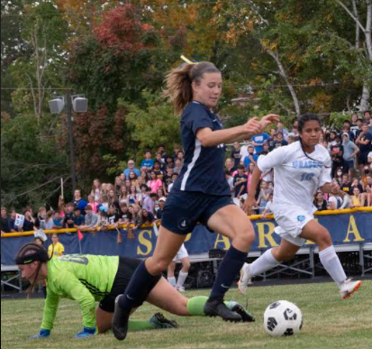 AN ACCELERATING ATHENA. Soccer captain Naomi Straub strides towards the net to take a shot.