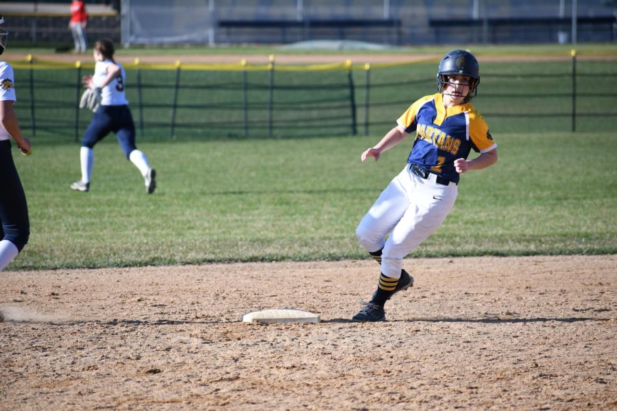 RUNNING THE BASES. Georgia Ross surveys the infield as she sprints to second base.
