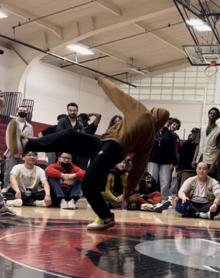 JUMPING INTO ACTION. Masumi Kouakou jumps into the air as the crowd watches in awe. “I feel like they think its different,” Kouakou said of how his peers at school react to his dancing. 