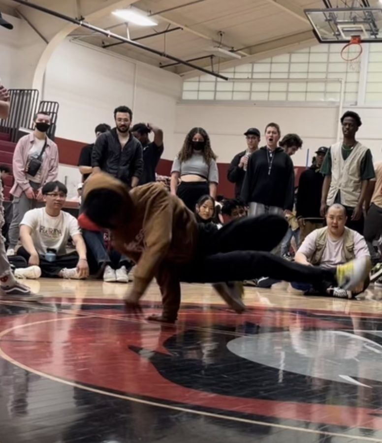 ROUND AND ROUND. Masumi Kouakou does a 360 on the ground as the crowd observes. He feels comfortable dancing at his studio, because metaphorically, he feels that they all are in the same room.”