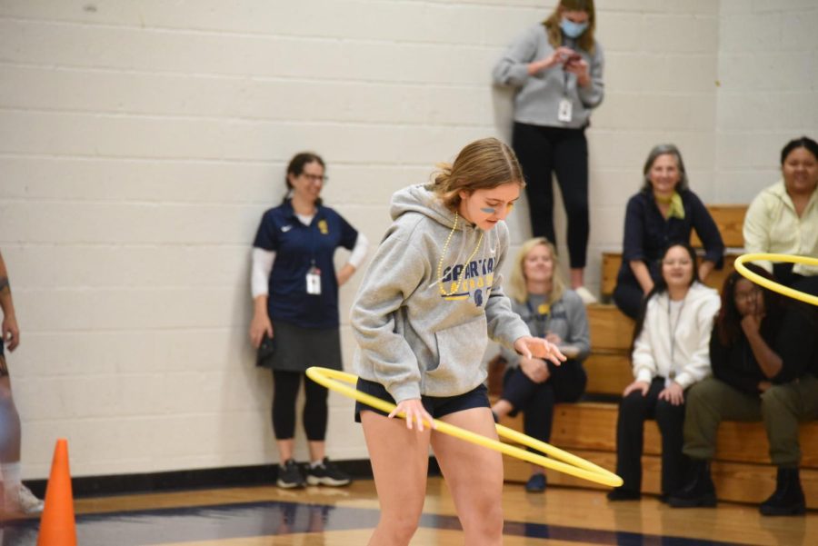 HULA HOOP. Charlotte Goings, one of the competitors chosen for the junior class, hula-hoops as fast as she can to reach the free-throw line of the basketball court. 