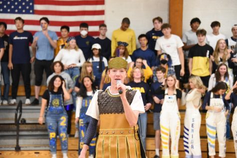 LETS ALL DO THE SPARTAN BEAT. Senior Spartan Tommy Verhey leads the students and faculty in chanting The Spartan Beat, an SPA tradition.