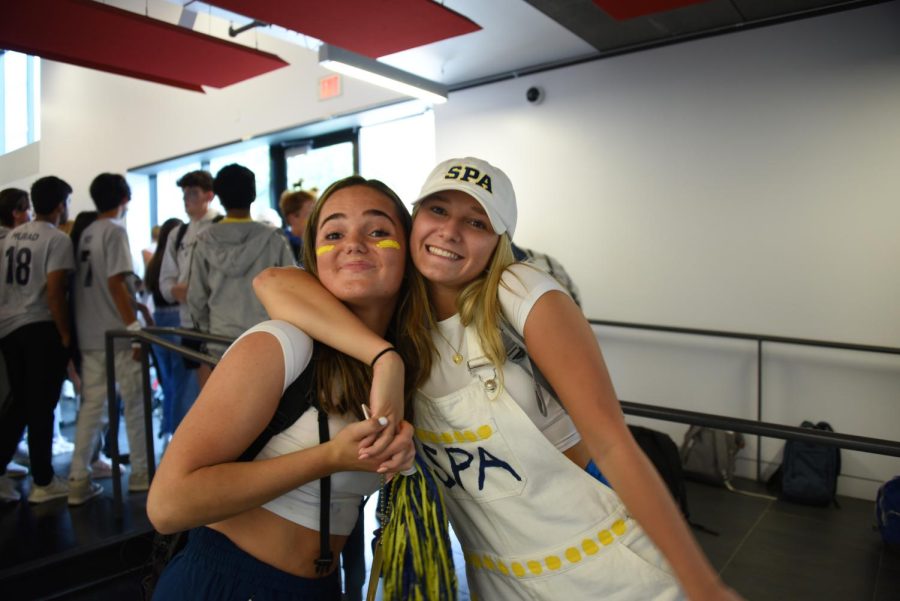 GOOD TIMES. Junior Natalie Vogenthaler and senior Johnna Melk-Johnson are decked out in school spirit. Melk-Johnsons senior overalls have pops of blue and yellow paint on them to represent SPAs school colors.