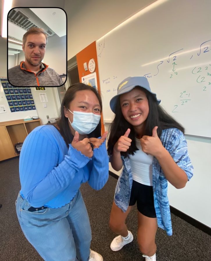 SAY CHEESE. Seniors Naysa Kalugdan and Julia Colbert enlisted upper school math teacher Zach Sheffert to take their BeReal in a math classroom at school.