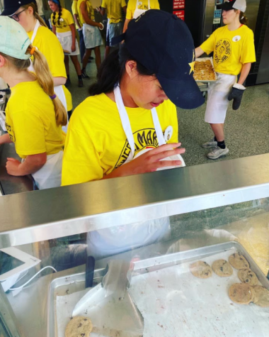 SMILING AND SCOOPING. Senior Julia Colbert scoops approximately four dozen cookies into one of Sweet Marthas signature buckets. 