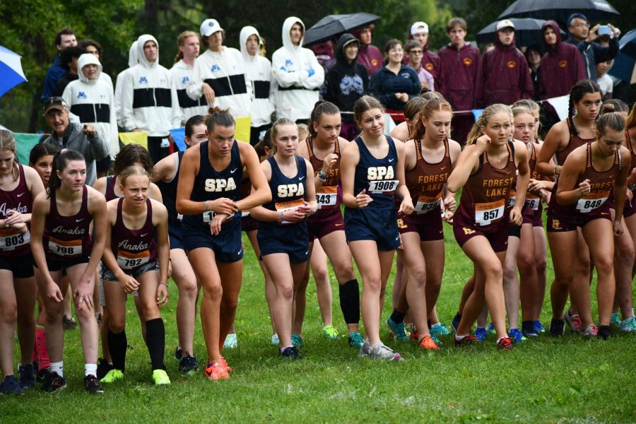 Runner prepare themselves. Members of the girls cross country team get into position before their race begins. 