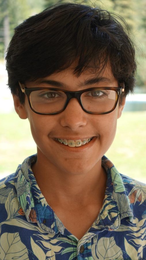 Deviyani Nelson smiles for the camera in her Hawaiian shirt, showing off her smile and style. 