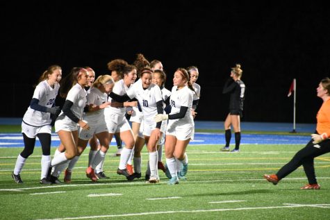 SWEET CELEBRATION. After the Spartans take the lead in the first half, the whole team joins to congratulate Bollinger Danielson on her successful shot.