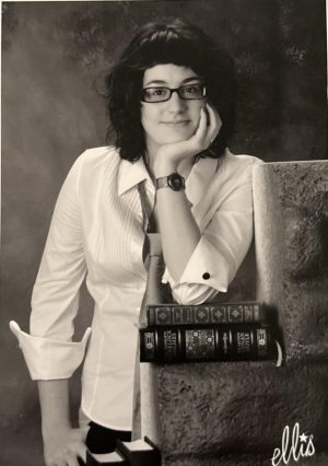 SAY CHEESE. Gokhberg casually rests her elbow on top of a stack of books as she poses for her high school picture. 