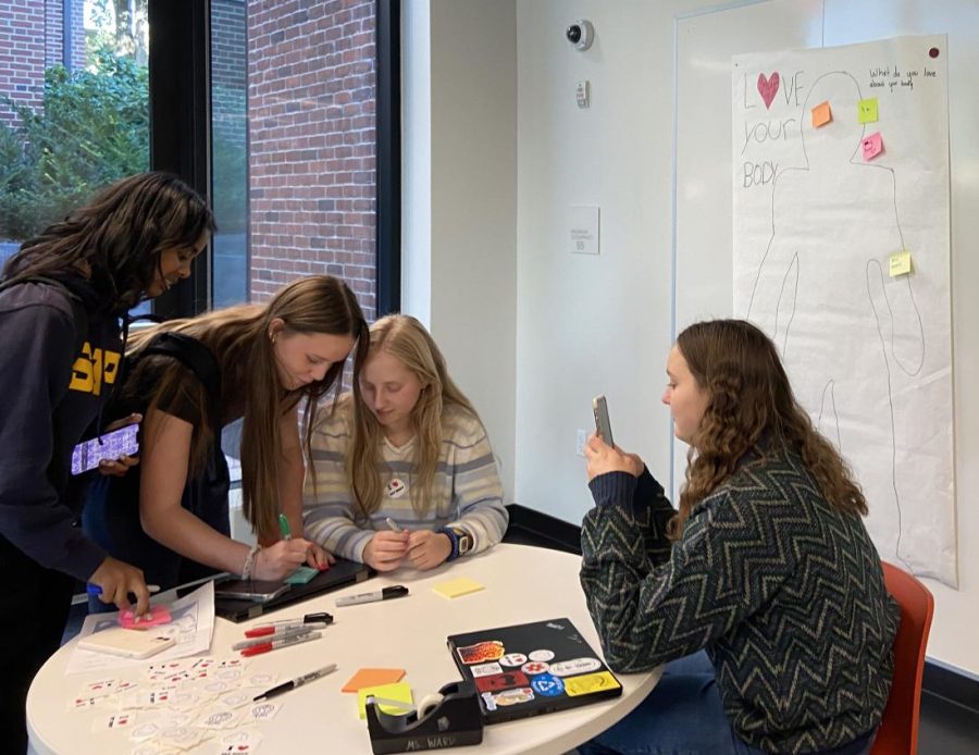 SIGN HERE. HerSpace co-leader Clara Bagnoli hosts the LYBD table in lower Schilling on Sept. 26.