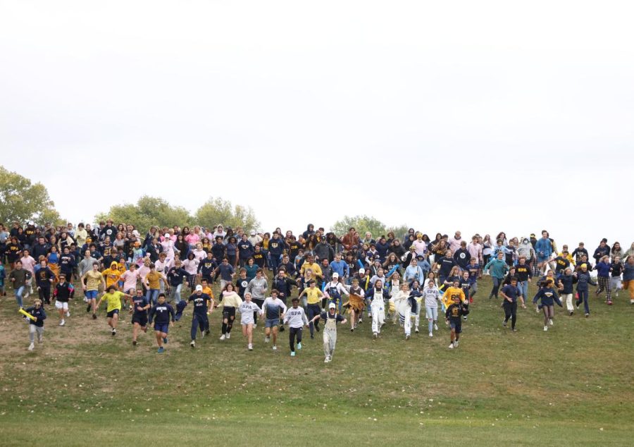 FIELD FANS. Leo Sampsell-Jones leads the traditional storming of the field.