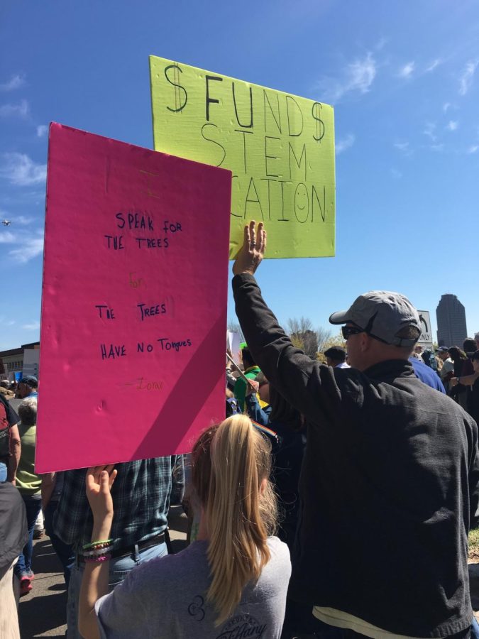 THE+VOICE+IS+OURS.+Leatham+and+her+dad+hold+signs+at+a+protest+against+climate+change.