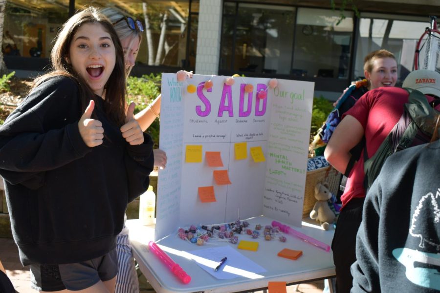 EYE-CATCHING. Student-leaders grab the attention of their peers with candy and colorful posters.