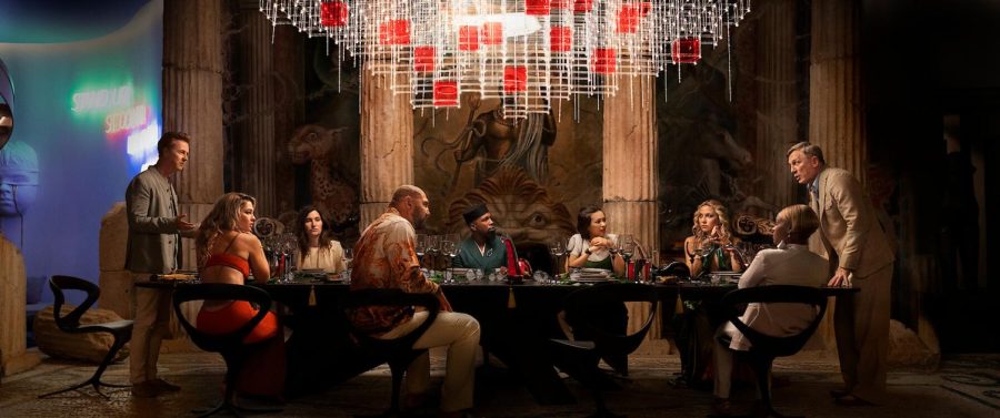 The gaggle of characters sit around the table for a meeting.
Cred: Netflix Press Kit