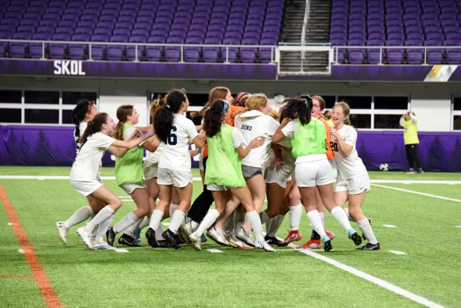 THE SPARTANS SUCCEED. After the end of the shootout, the team crowds goalie Lindsay Browne in celebration.