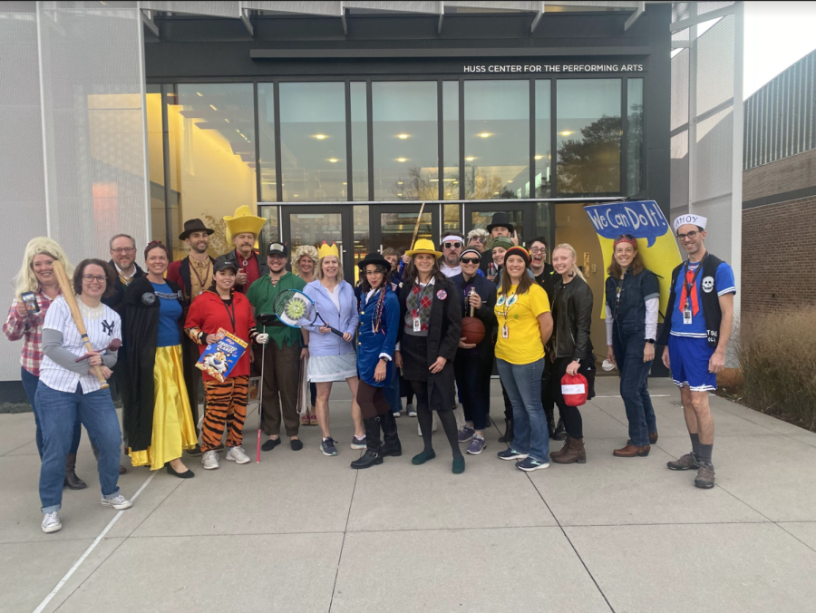 HALLOWEEN WELCOME. The faculty participants in the before-and-after contest line up in front of the Huss doors to welcome students to school Oct. 31.