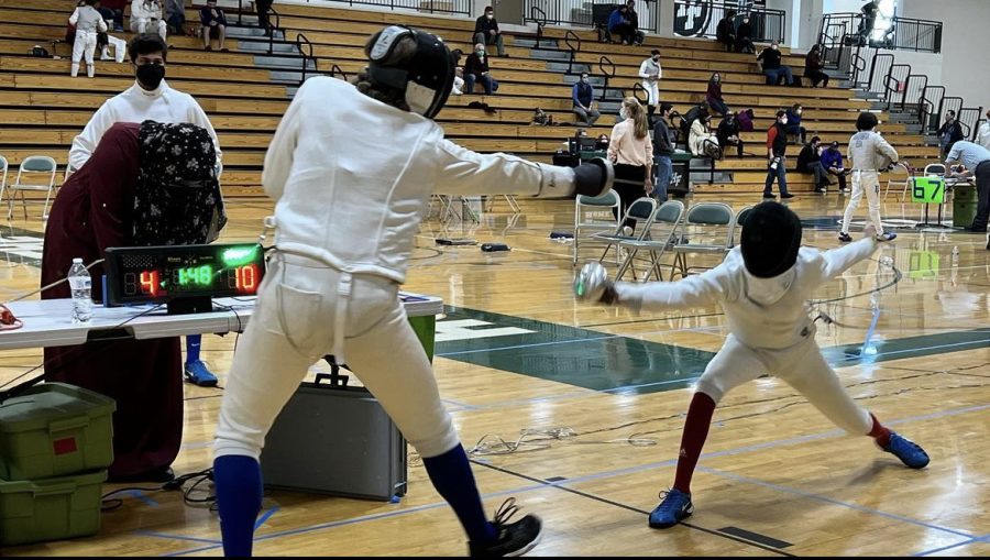 FENCING FOOTWORK. Captain Milan Misra spars with an epee opponent during a tournament last year. Finding the balance between support and competitive spirit is the captains’ focus: Mishra said, “Having a very strong team is going to help us get the wins that we want.” 