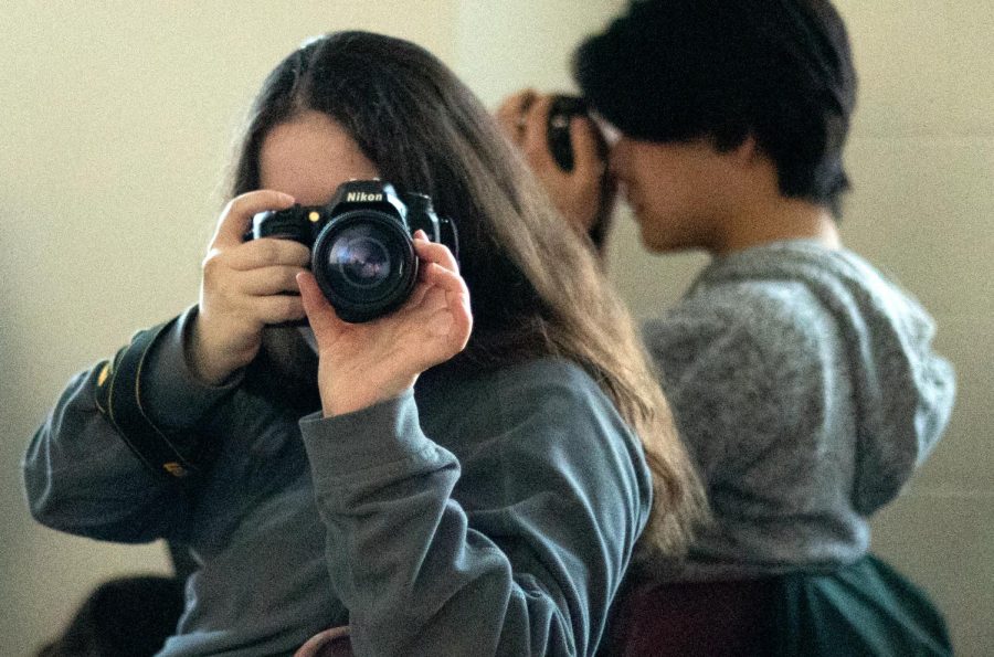 TAKE A SHOT. Ibid Yearbook Editor in Chief Leona Barocas frames a portrait as The Rubicon Feature editor Eliza Farley snaps a portrait of her at a photo workshop on campus this winter.