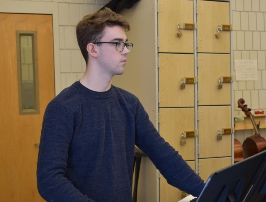 PLAYING ALONG. Senior Nolan Wagner plays keyboards during rehearsal while the orchestra plays his original composition, Diomedes.