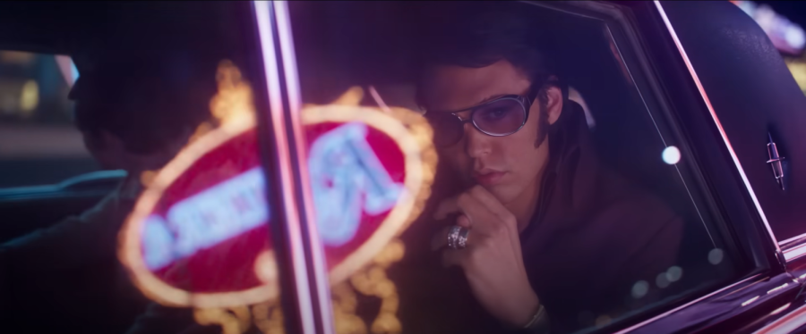 BEHIND THE LIGHTS. Elvis, directed by Baz Luhrmann and starring Austin Butler, provides an insider view into the stars life, marred by controversy and greed. The film is nominated for eight Oscars, including Best Picture. (Screen capture from Baz Luhrmanns ELVIS | Official Trailer by Warner Bros. Pictures on YouTube)