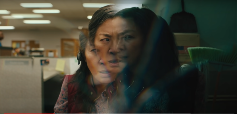 CONNECTED TO THE MULTIVERSE Evelyn Wang (Michelle Yeoh)'s consciousness "fracturing" from successfully connecting with the multiverse. Evelyn is half in her universe, doing an audit meeting, and half in another universe, where she is in a broom closet. While gasping for air out of shock, Wang asks in a panic, "What's happening?" 