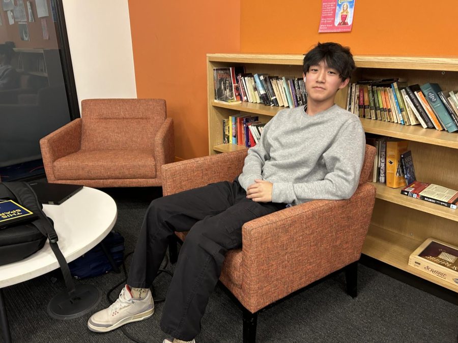 SILENT SOCIALIZING. Senior Andrew Bai appreciates the calm nature of the English hallway commons. "I've kind of always been hanging out here with my friends and it's quieter than Schilling," he said.