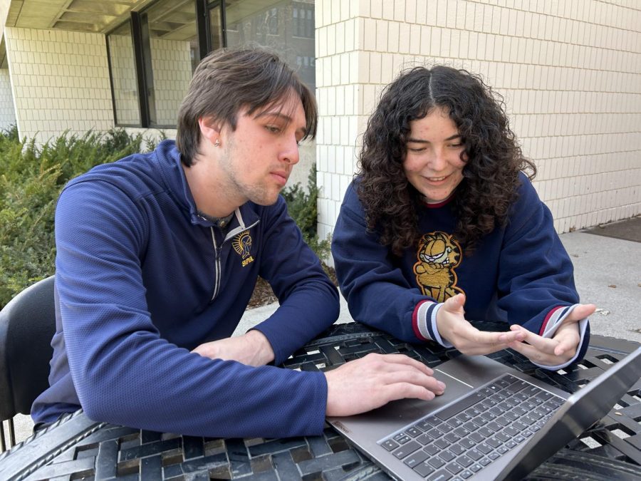 GAME DESIGN GURUS. Maryeva Gonzalez discusses her game with fellow senior Roberto Velez. The two of them will finish building the game as part of their senior projects.