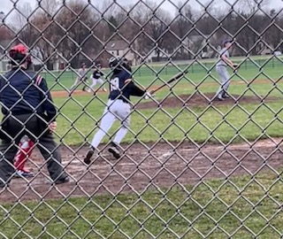 WATCH THE BALL. Sophomore Liam Huddleston looks into the sky for the ball he’s just hit. Huddleston began to run for first base shortly after.