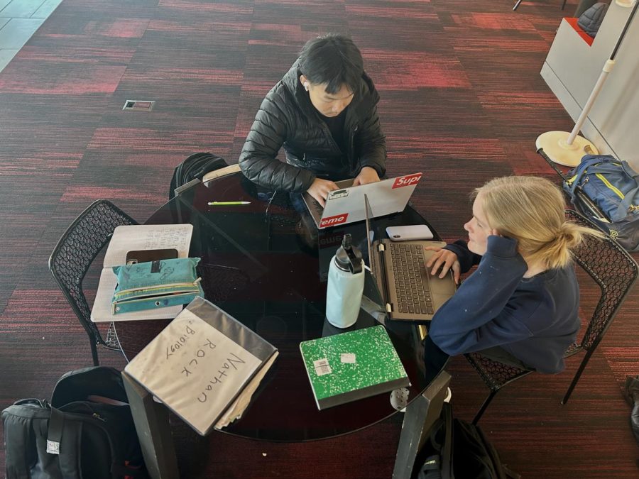 HARD WORK IN HUSS. Sophomores Sawyer Bollinger Danielson and Mason Hang like to use their free periods efficiently and spend time with friends. "I like to hang out in Huss because it's a safe space where I can spend time with friends and take care of my academic necessities," Hang said.