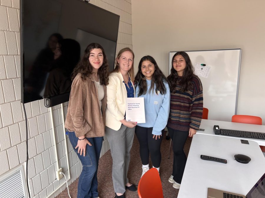 Lundquist poses with students after her presentation