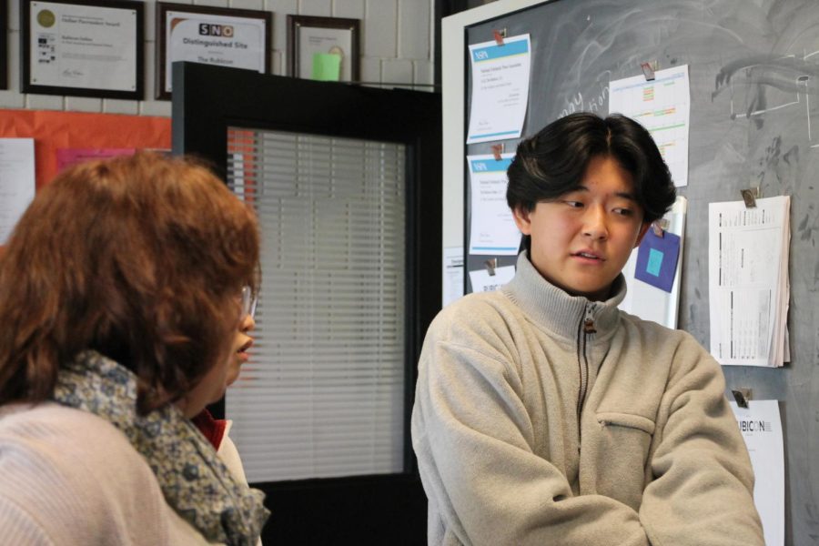 BECOMING A LEADER. Orion Kim discusses design options with fellow staff members on The Rubicon. He worked around the busy room, assisting others with polishing their pages. Im the Co-Editor-In-Chief next year so I want to develop my leadership [and] become more comfortable with it, Kim said.