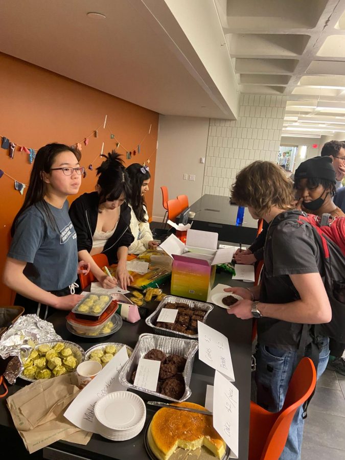FLAVORFUL FUNDRAISER. Members of Asian Student Alliance run the bake sale table during the month of May to gather donations to Asian Media Access. In the end, a total of $319 was raised selling various Asian delights.