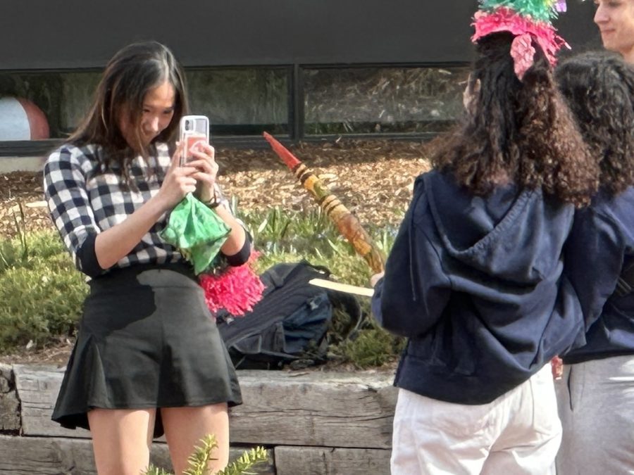 LOOK HERE. Creative Design Manager Rita Li knows that the best camera is the one you have with you. Here, she takes a photo after the Latinos Unidos Cinco de Mayo celebration May 5.