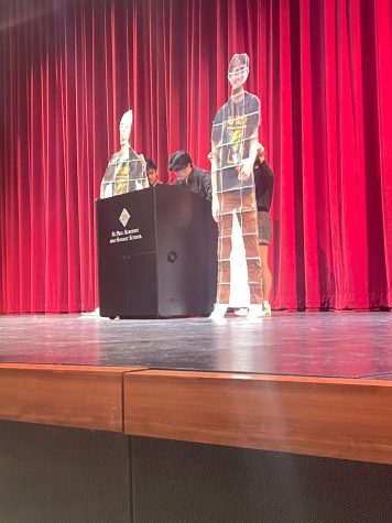 BIG HENRY. Juniors Orion Kim and Henry Hilton took stage in an unusual manner. Hilton, who was in D.C. for a semester away program, wasn’t able to make an in-person appearance. Instead, two volunteers walked on stage with large cardboard cutouts. 
