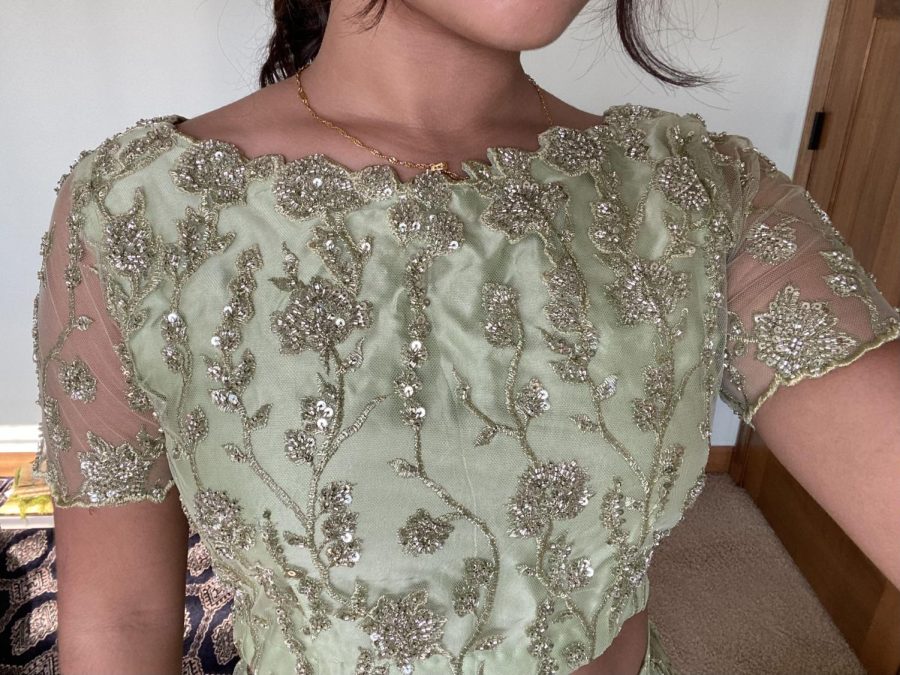 GREEN GODDESS. Junior Wafa Naqvi's prom outfit features a sparkly green lehenga, which is a traditional Pakistani skirt with a matching cropped shirt. This look is one-of-a-kind and Naqvi plans to re-wear it for future special events to get the most out of the beautiful, handmade lehenga.