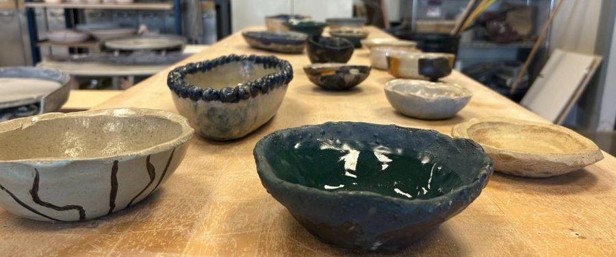 BOWLS GALORE: One of many tables in the ceramics studio, complete with a stockpile of student pieces.