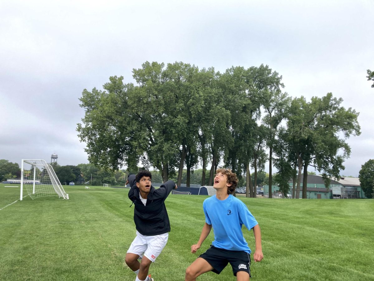 LOOK UP! Sophomores Juan Miguel Adams and Patrick Wall prepare to catch a frisbee. These students took advantage of their free period to get outside. It was a great way to start the year, Juan Miguel said. [9-10]