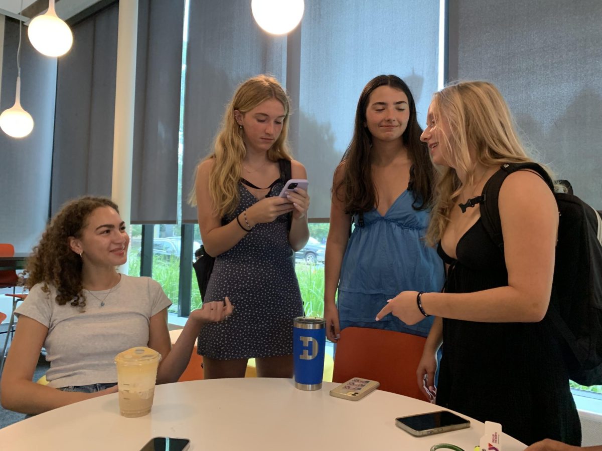 COFFEE & CHATTER. Seniors gather in Lower Schilling in the early morning hours to catch up before advisory begins. Coffee, energy drinks, and other caffeinated beverages are a must for the first day of school after a summer of sleeping in.